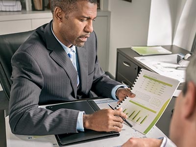 Businessman pointing to printed manual